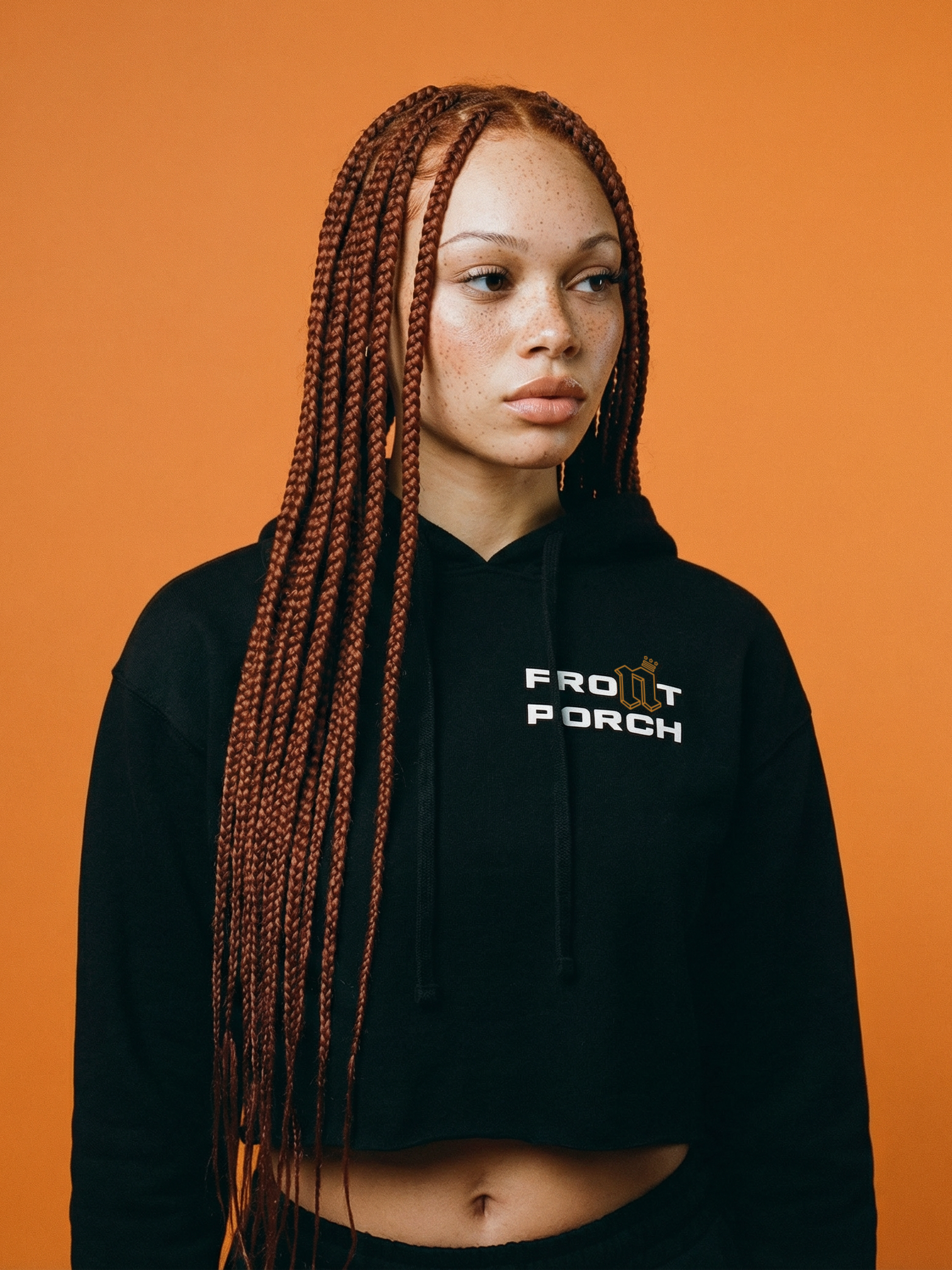 Front Porch Freestyles Ladies OG Cropped Hoodie black worn female model orange background crop fit lifestyle