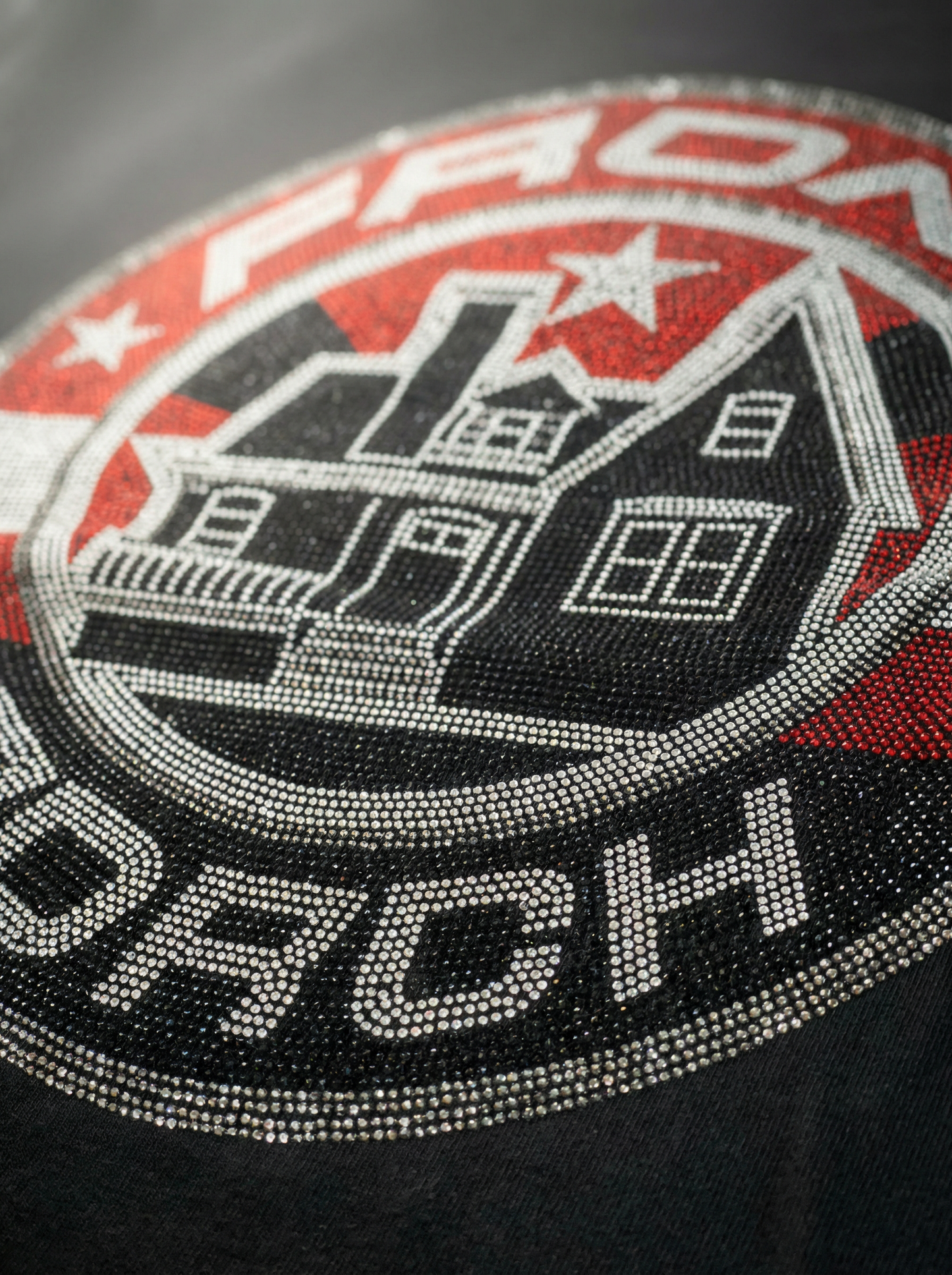 Closeup of crystal rhinestone star graphic on Front Porch Freestyles Shining Star crewneck in black