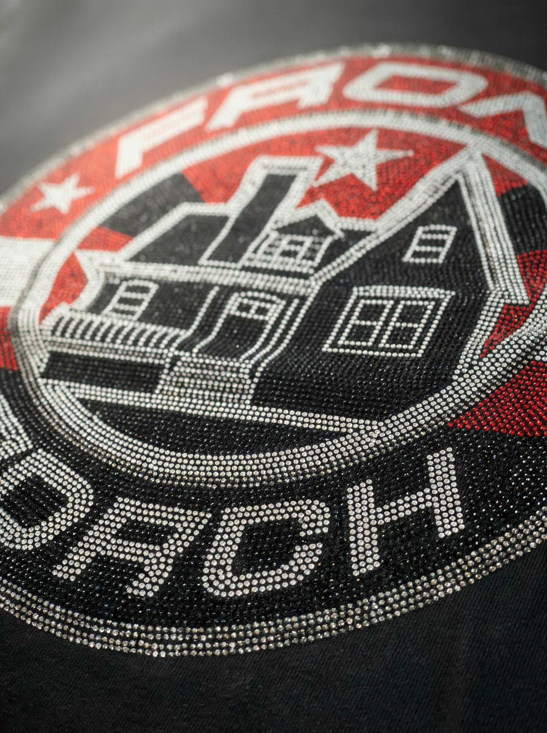 Closeup of crystal rhinestone star graphic on Front Porch Freestyles Shining Star crewneck in black